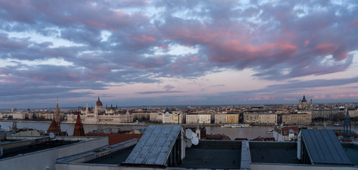 Panoramic view from Pest house balcony of Danube river side with Hungarian Parliament at dusk