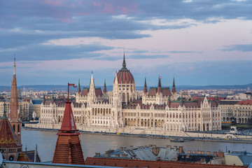 Fototapeta na wymiar Danube river side view of Hungarian Parliament after sunset at dusk in winter