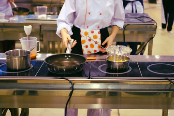 The cook prepares meals in the large shared kitchen in the dining room