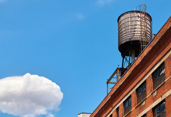 Rooftop water tank on a sunny day, one of the symbols of New York City, USA.