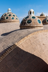 Rooftop with small domes and circle glasses in sunny day in Khasan, Iran.
