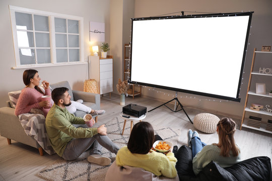 Young Friends Watching Movie At Home