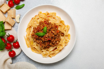 Italian pasta tagliatelle with traditional homemade meat sauce (4 hours of cooking) -  bolognese sauce. Top view. White background. Close up.