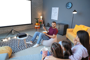 Young family watching movie at home