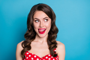 Closeup photo of pretty funny wavy lady licking plump tempting lips look side empty space dream of yummy tasty dinner wear red dotted dress singlet isolated blue color background - obrazy, fototapety, plakaty