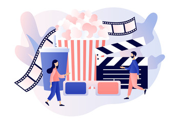 Obraz premium Online cinema. Mobile movie theater. Cinematography. Tiny people watching movie with popcorn,3d glasses and video attributes. Modern flat cartoon style. Vector illustration on white background