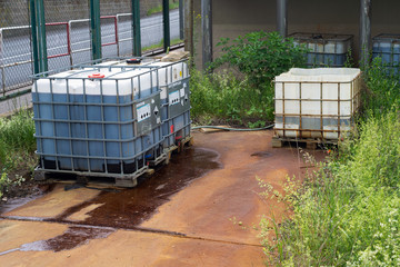 Chemical factory plastic container leaking pollution leak rusty spill