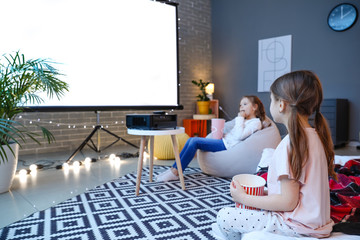 Little girls watching movie at home