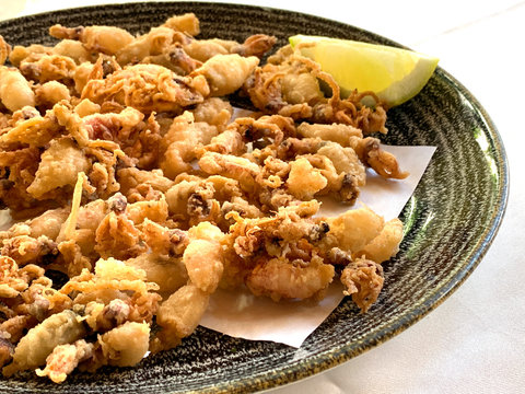 Fried and battered baby squid with lemon. A typical spanish tapa called chipirones fritos.