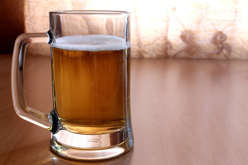 A glass of beer is on the table