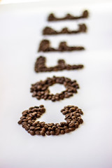 Roasted coffee beans isolated on a white background. Word 