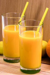 Orange juice in a glass with a straw. Nectar of fruit. Cocktail.