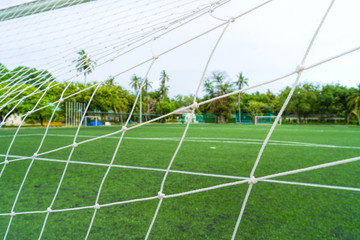 Volleyball net on a deserted sandy beach on the tropical sea.