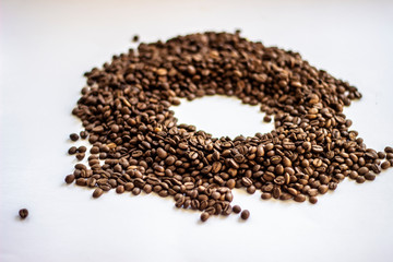 Coffee beans isolated on white background with place for text. Frame of coffee beans on white background. Closeup of coffee beans on plain paper.