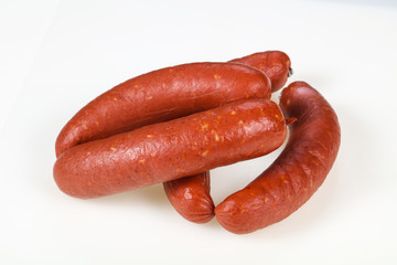 Tasty meat sausages over white background