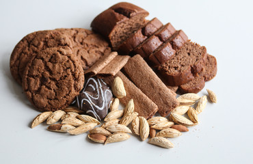different pastries and almonds on a white background close up