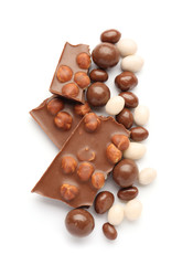 Tasty chocolate candies with nuts on white background