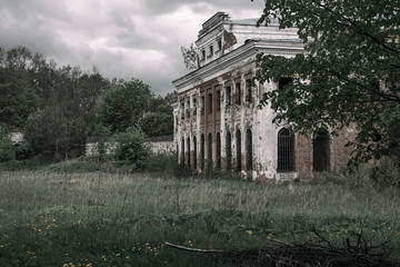 Old lonely abandoned manor stands in a quiet forest