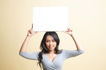 Young Asian woman with white blank sign.