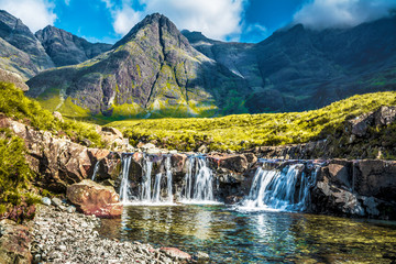 Fairy pools in Skye island with mountains on a background