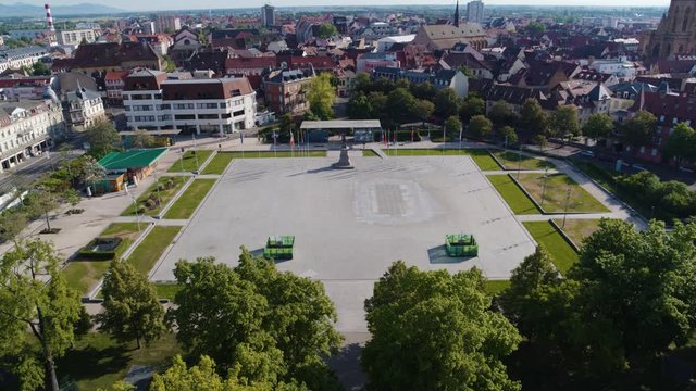 Aerial drone shot of the city of Colmar in Alsace France. Quiet street during summer with blue sky. Place Rapp.