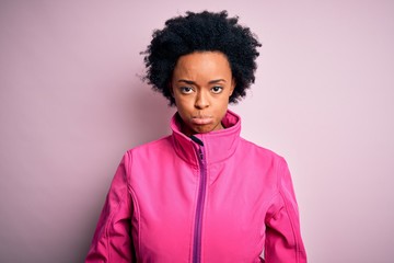 Fototapeta na wymiar Young African American afro sportswoman with curly hair wearing sportswear doin sport depressed and worry for distress, crying angry and afraid. Sad expression.
