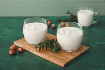 Glasses of tasty hazelnut milk on table