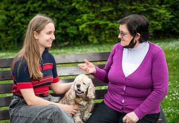 Happy smiling teen granddaughter with senior grandmother