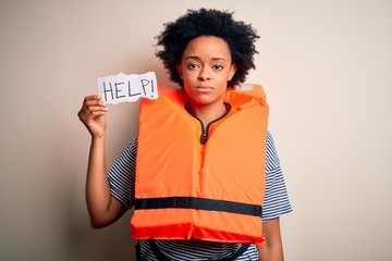Young African American afro woman with curly hair wearing lifejacket holding help paper with a...