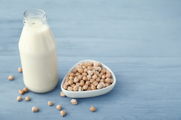 Bottle of tasty chickpea milk on table