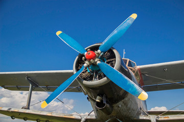 old airplane against the sky. vintage biplane on the field