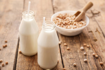 Bottles of tasty chickpea milk on table