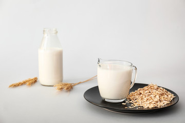 Tasty oat milk on light background