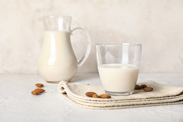 Tasty almond milk on white background