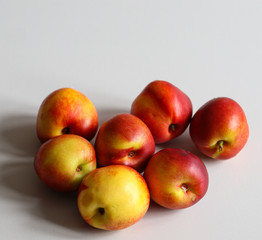 ripe fresh nectarines on a white background close up