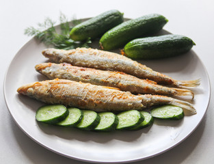 fried fish with vegetables on a plate
