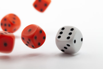Playing dice at white wooden background.