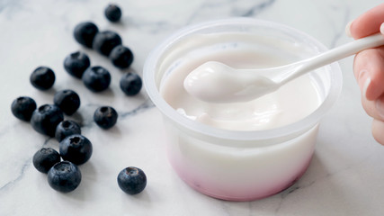 Eating Greek Yogurt. Plain Greek yogurt in spoon