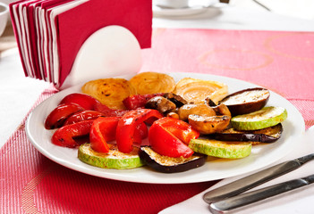 Plate of baked vegetables.On table.
