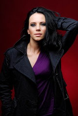 Yang woman on a red background in studio., fashion