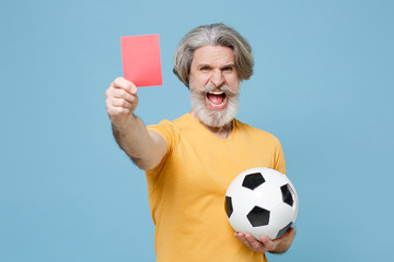 Elderly gray-haired mustache bearded man in yellow t-shirt isolated on blue background. Sport...