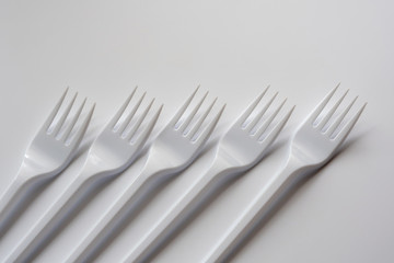 Five plastic forks isolated on white background. Copy space..