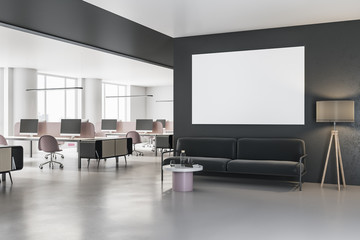 Contemporary coworking office with blank poster on wall and sofa in hall.