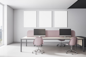 Contemporary coworking office interior with three blank posters