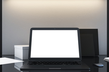 Blank white mock up screen of laptop on table.