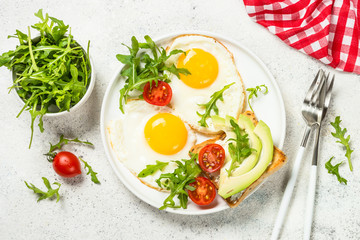 Healthy breakfast with egg, toast and salad.