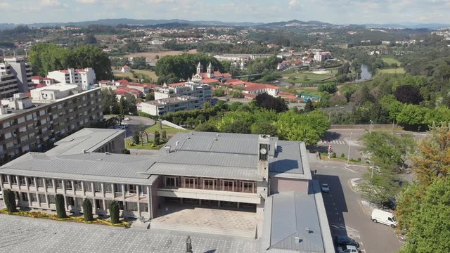 AERIAL DRONE FOOTAGE - Santo Tirso City Hall with the statue of Saint Rudesind (Sao Rosendo) in front. The Monastery of Saint Benedict (Sao Bento) in the background, Santo Tirso, Portugal.