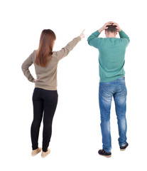 Back view of couple in sweater with mobile phone.