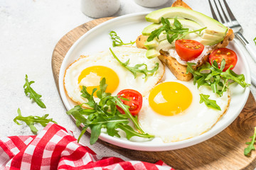Healthy breakfast with egg, toast and salad.