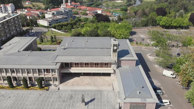 AERIAL DRONE FOOTAGE - Santo Tirso City Hall with the statue of Saint Rudesind (Sao Rosendo) in front, the 25th of April Square (Portuguese: Praca 25 de Abril) , Santo Tirso, Portugal.